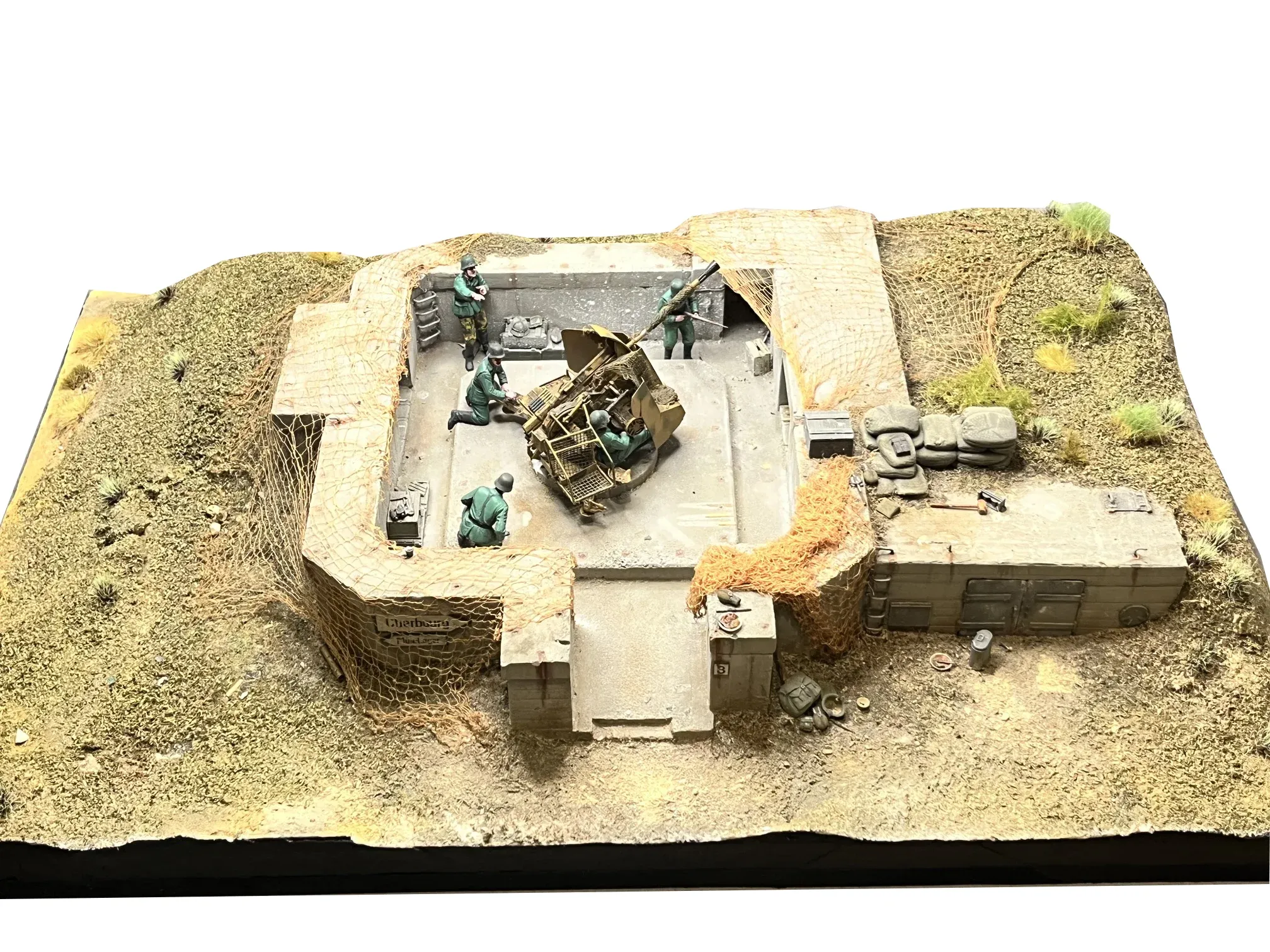 Vue d’ensemble : un bunker en béton et ses servants autour d’une pièce d’artillerie